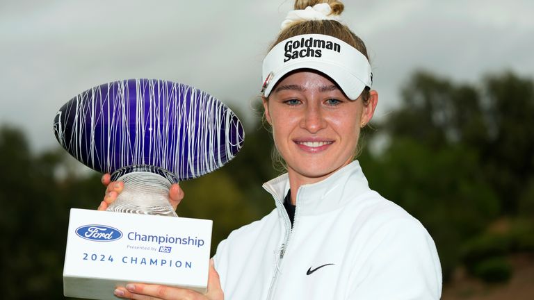 Nelly Korda smiles as she poses for photographs with the trophy after winning the PGA Ford Championship golf tournament Sunday, March 31, 2024, in Gilbert, Ariz. (AP Photo/Ross D. Franklin)