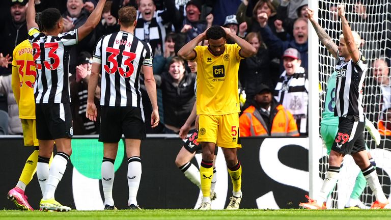 Sheffield United players look dejected as Newcastle celebrate their fourth goal