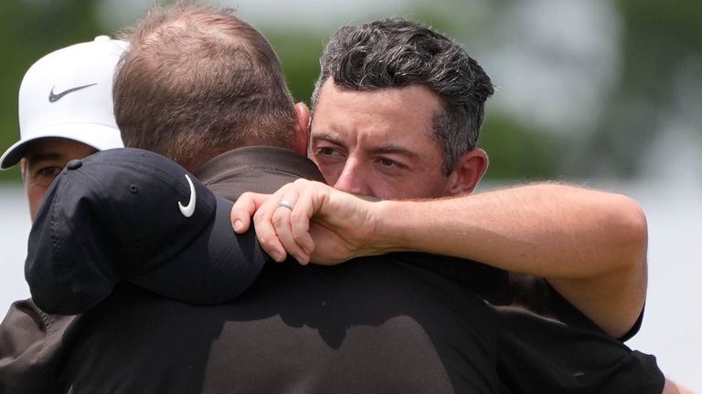 Rory McIlroy of Northern Ireland congratulates his teammate Shane Lowry of Ireland after ending the day on the ninth green during the second round of the PGA Zurich Classic golf tournament at TPC Louisiana in Avondale, La., on Friday, April 26.  2024. (AP Photo/Gerald Herbert)