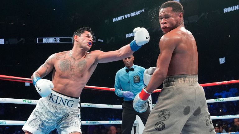 Ryan Garcia, left, punches Devin Haney during the 12th round of a super lightweight boxing match Sunday, April 21, 2024, in New York. (AP Photo/Frank Franklin II)