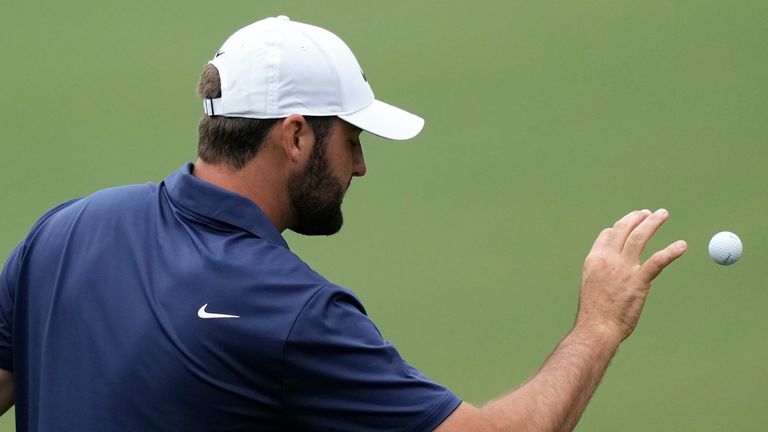 Scottie Scheffler catches a golf ball on the driving range during a practice round in preparation for the Masters golf tournament at Augusta National Golf Club Tuesday, April 9, 2024, in Augusta, Ga. (AP Photo/Charlie Riedel)