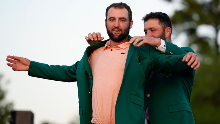 Jon Rahm, of Spain, puts the green jacket on winner Scottie Scheffler after the Masters golf tournament at Augusta National Golf Club Sunday, April 14, 2024, in Augusta, Ga. (AP Photo/Matt Slocum)