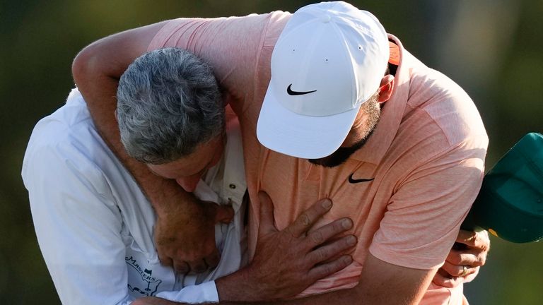 Scottie Scheffler celebrates with his caddie Ted Scott after winning the Masters golf tournament at Augusta National Golf Club Sunday, April 14, 2024, in Augusta, Ga. (AP Photo/David J. Phillip) 