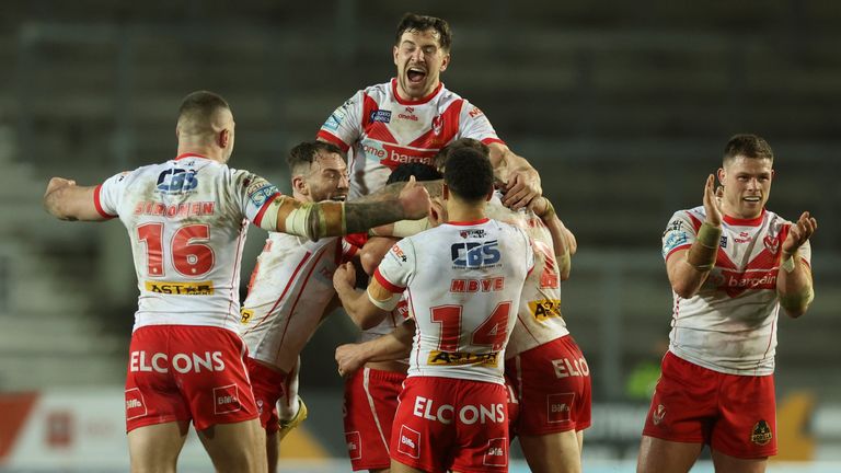 Picture by Paul Currie/SWpix.com - 25/04/2024 - Rugby League - Betfred Super League Round 9 - St Helens v Huddersfield Giants - The Totally Wicked Stadium, St Helens, England - St Helens' Jonny Lomax scores a last minute drop goal and celebrates with team mates 