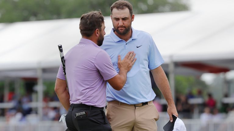 Stephan Jaeger, left, pats Scottie Scheffler on the chest after they finished the Houston Open golf tournament Sunday, March 31, 2024, in Houston. Jaeger won, and Scheffler tied for second. (AP Photo/Michael Wyke)