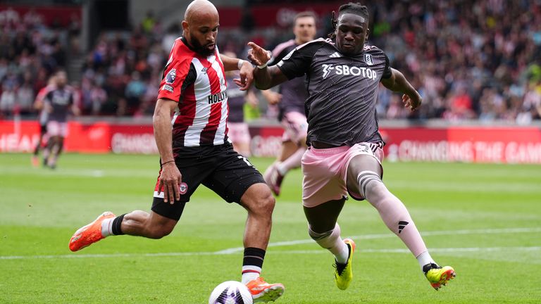 Brentford's Bryan Mbeumo shoots under pressure from Fulham's Calvin Bassey
