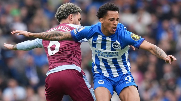 Aston Villa's Douglas Luiz and Brighton's Joao Pedro battle for the ball 