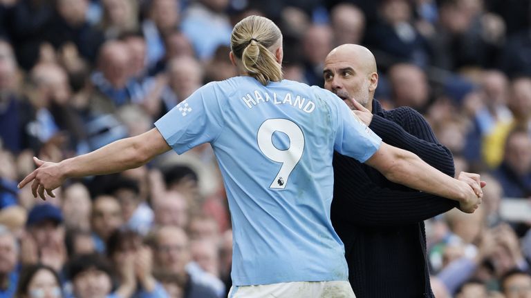 Erling Haaland speaks with Pep Guardiola after being substituted