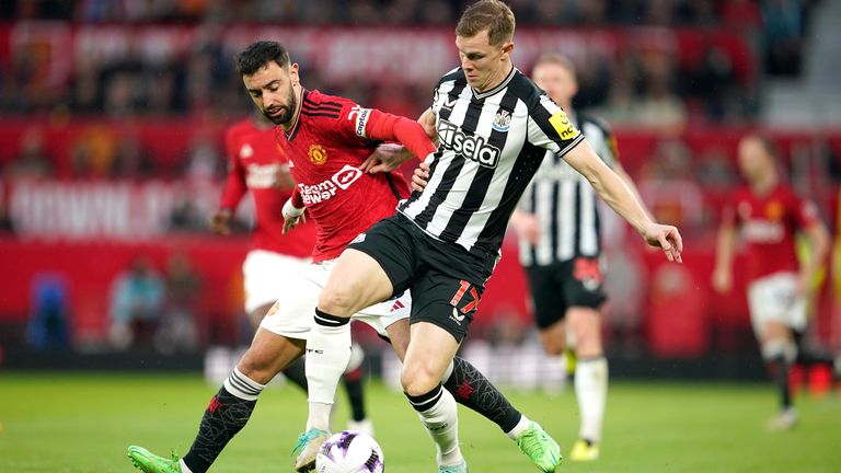 Manchester United's Bruno Fernandes challenges for the ball with Newcastle's Emil Krafth