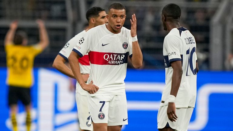 PSG's Kylian Mbappe, center, reacts after Dortmund's Niclas Fuellkrug scoring his side's opening goal