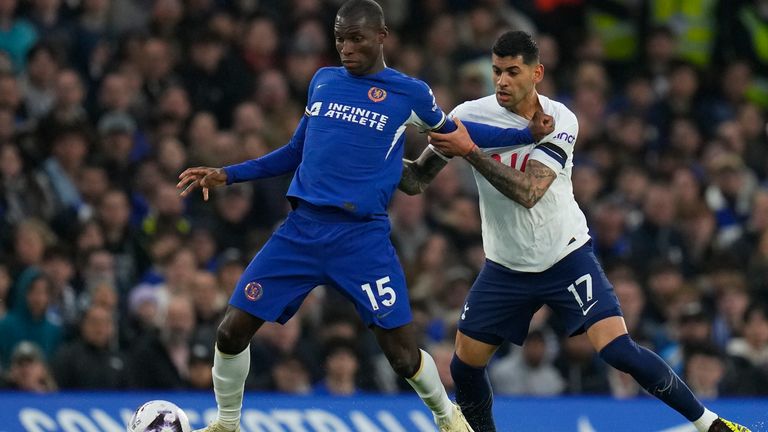 Chelsea's Nicolas Jackson, left, is challenged by Tottenham's Cristian Romero