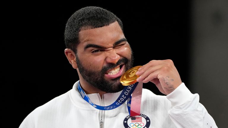 Gable Steveson poses with his gold medal during the medal ceremony for the men's freestyle 125kg wrestling at Tokyo Olympics