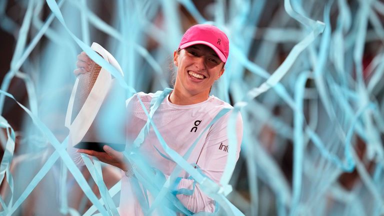 Poland's Iga Swiatek holds the trophy after winning the women's final match against Aryna Sabalenka of Belarus, at the Mutua Madrid Open tennis tournament in Madrid, Spain, Saturday, May 4, 2024. (AP Photo/Bernat Armangue)