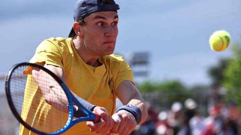 Britain's Jack Draper plays a backhand return to Dutch Jesper de Jong during their men's singles match on day one of the French Open tennis tournament at the Roland Garros Complex in Paris on May 26, 2024. (Photo by Anne-Christine POUJOULAT / AFP)