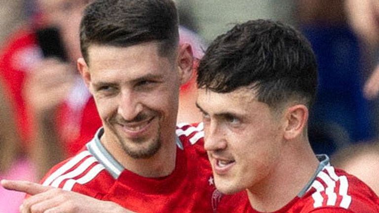 DINGWALL, SCOTLAND - MAY 19: Aberdeen's Jamie McGrath celebrates with Ester Sokler after scoring to make it 2-1 during a cinch Premiership match between Ross County and Aberdeen at the Global Energy Stadium, on May 19, 2024, in Dingwall, Scotland.  (Photo by Ross Parker / SNS Group)