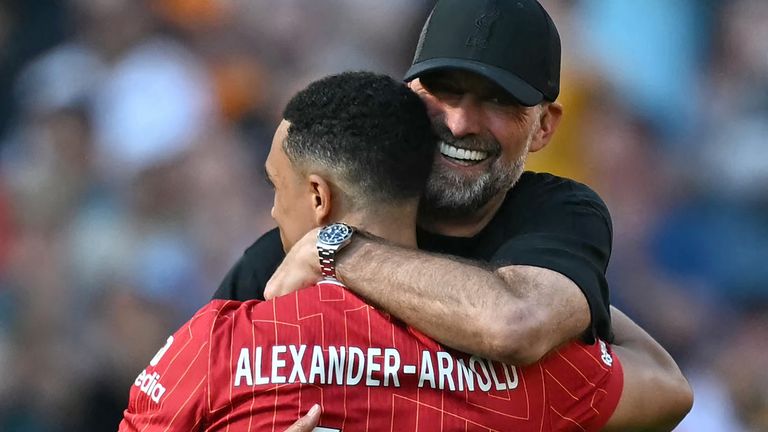 Jurgen Klopp embraces Trent Alexander-Arnold on the pitch at full time