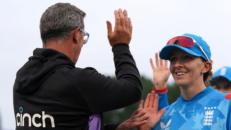 Kate Cross celebrates England's victory over Pakistan in the first ODI in Derby with head coach Jon Lewis