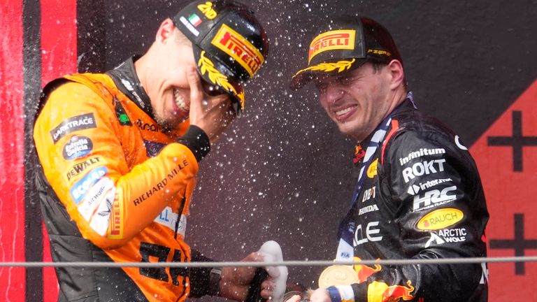 second placed McLaren driver Lando Norris of Britain, left, celebrates on the podium with winner Red Bull driver Max Verstappen of the Netherlands after the Italy's Emilia Romagna Formula One Grand Prix race at the Dino and Enzo Ferrari racetrack in Imola, Italy, Sunday, May 19, 2024. (AP Photo/Luca Bruno)