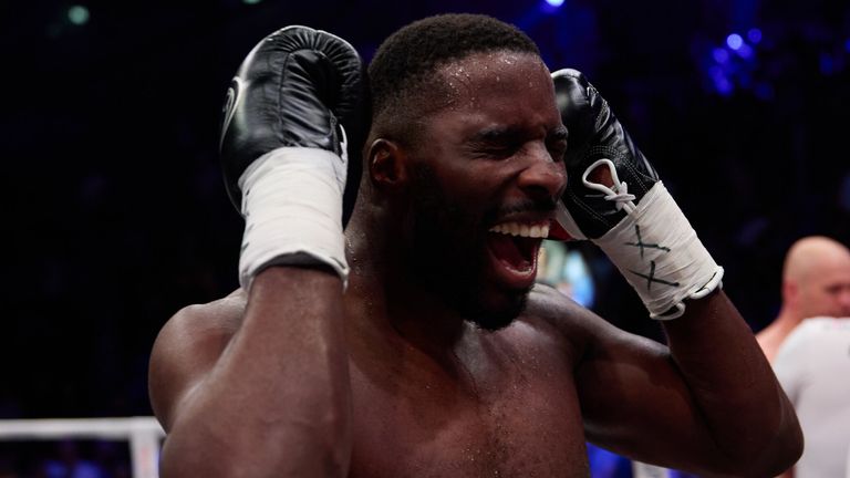 Lawrence Okolie celebrates becoming a two-weight world champion