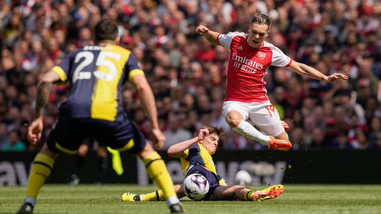 Arsenal's Leandro Trossard skips over the challenge of Bournemouth's Alex Scott