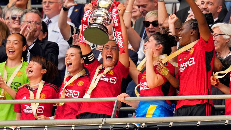 Manchester United captain Katie Zelem lifts the FA Cup trophy