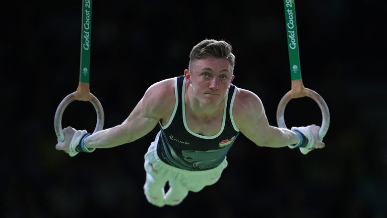 England's Nile Wilson on the Still Rings on his way to winning a gold medal in the Men's Individual All-Round Final with coach Ben Collie at the Coomera Indoor Sports Centre during day three of the 2018 Commonwealth Games in the Gold Coast, Australia. 
