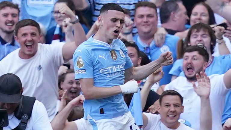 Phil Foden leaps in celebration after scoring his second goal against West Ham