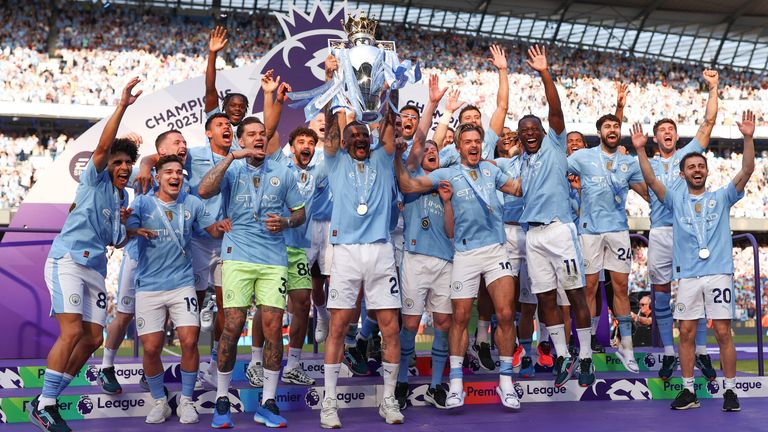 Manchester City players celebrate winning the Premier League for the fourth successive season