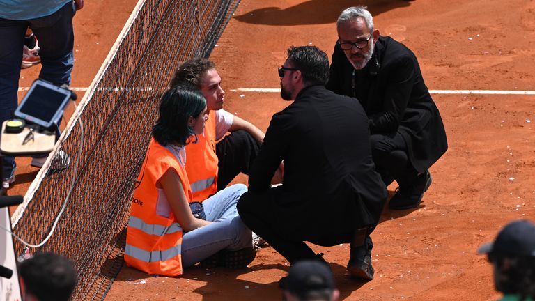 Protesters block the court during the Men's Doubles Round of 16 match between Marcelo Arevalo and Mate Pavic, and Santiago Gonzalez and Edouard Roger-Vasselin