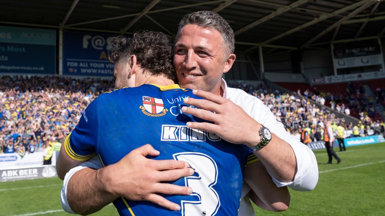 Picture by Olly Hassell/SWpix.com - 19/05/2024 - Rugby League - Betfred Challenge Cup Semi Final - Huddersfield Giants v Warrington Wolves - The Totally Wicked Stadium, St Helens, England - Warrington Wolves Head Coach Sam Burgess celebrates with Toby King of Warrington after their sides victory over Huddersfield Giants