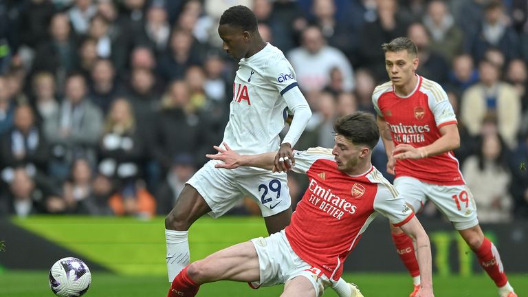 Sarr battles with Declan Rice during the north London derby
