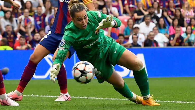 Barcelona goalkeeper Catalina Coll dives to divert a Lyon shot in the Women's Champions League final