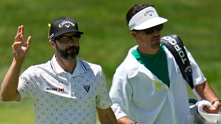 Adam Hadwin, left, waves after hitting the first green and teeing off in the final round of the Memorial golf tournament, Sunday, June 9, 2024, in Dublin, Ohio.  (AP Photo/Sue Ogrocki)