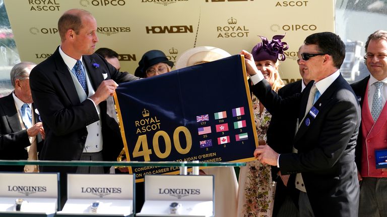 Trainer Aidan O'Brien with the Prince of Wales after being presented with a saddle cloth representing 400 group one winners 