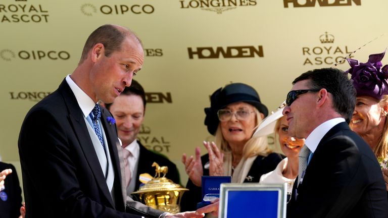 Aidan O'Brien receives the Prince Of Wales's Stakes prize from the man himself