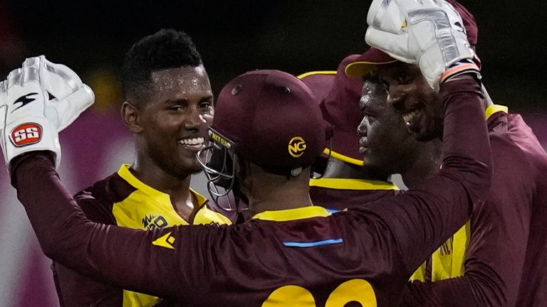 West Indies' Akeal Hosein celebrates with teammates after taking five wickets in his side's victory over Uganda