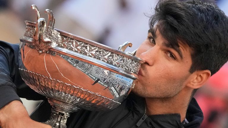 Spain's Carlos Alcaraz kisses the trophy after winning the French Open men's final against Alexander Zverev of Germany at the Roland Garros stadium in Paris, France, Sunday, June 9, 2024. (AP Photo/Christophe Ena)