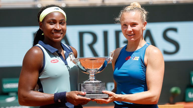 Coco Gauff and Katerina Siniakova pose with the trophy after winning the women's doubles final at the French Open (AP Photo/Jean-Francois Badias)