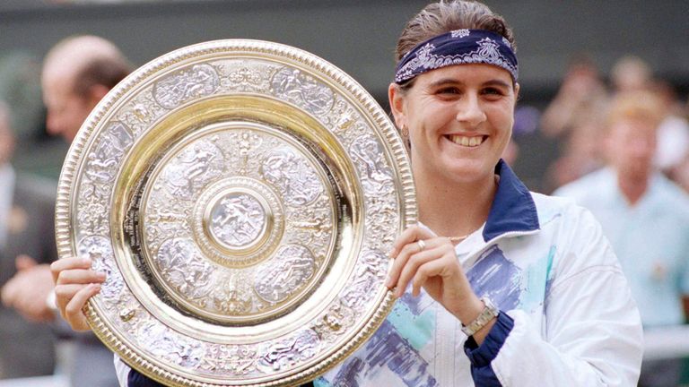 FILE - Conchita Martinez holds the trophy after winning the Women's Singles Final on Center Court in Wimbledon, July 2, 1994. Former Wimbledon champion Conchita Mart..nez has been named tournament director for the Billie Jean King Cup final.  Twelve national teams will play in Seville during the finals from November 7-12.  (AP Photo/Dave Caulkin, File)