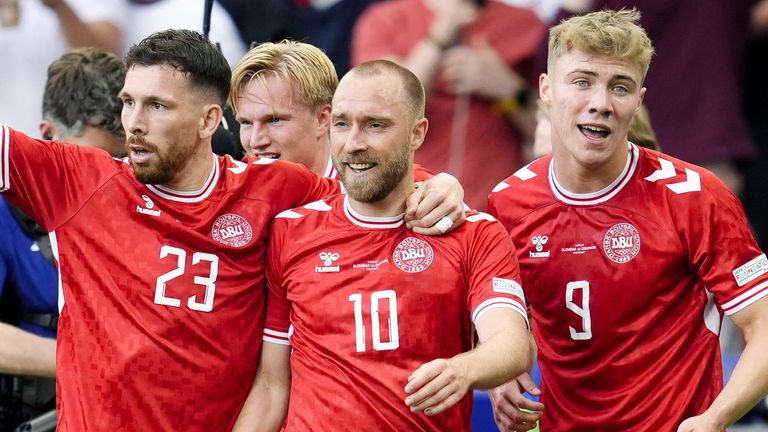 Christian Eriksen is congratulated by his team-mates after scoring Denmark's opening goal against Slovenia