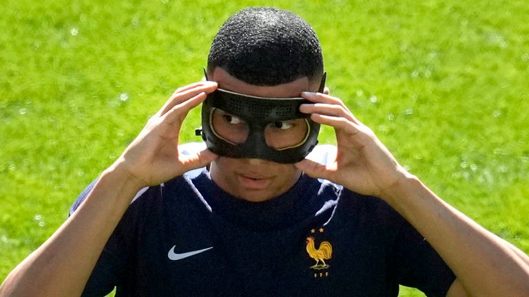 Kylian Mbappe fits a protective mask ahead France's clash with Poland