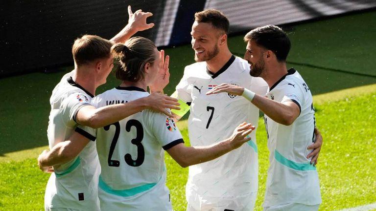 Austria players celebrate after taking the lead against the Netherlands through a Donyell Malen own goal