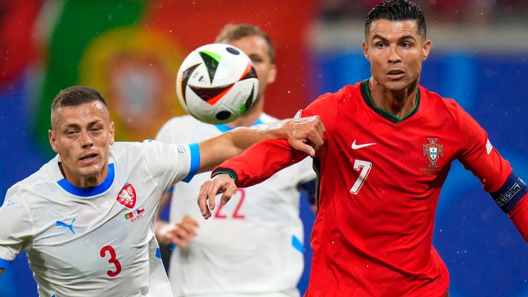 Portugal's Cristiano Ronaldo duels for the ball with Czech Republic's Tomas Holes