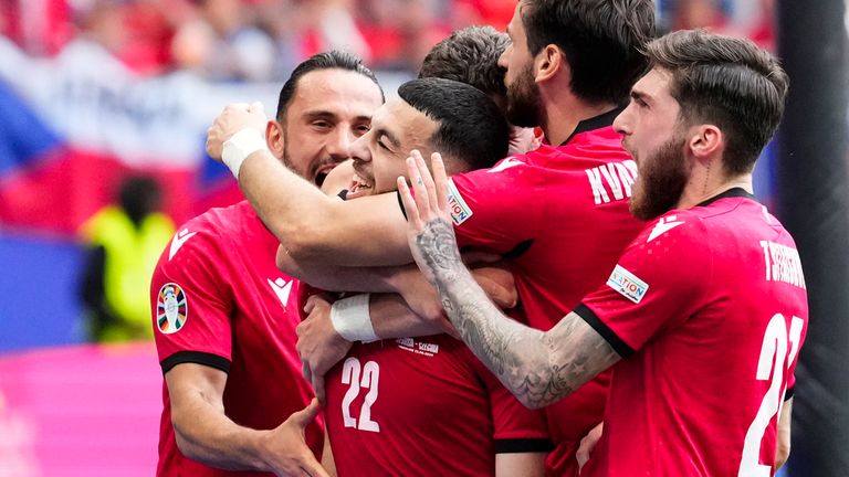 APTOPIX Georgia's Georges Mikautadze, center, celebrates with team mates after scoring his side's opening goal during a Group F match between Georgia and the Czech Republic at the Euro 2024 soccer tournament in Hamburg, Germany, Saturday, June 22, 2024. (AP Photo/Ebrahim Noroozi)
