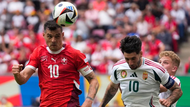 Switzerland's Granit Xhaka, left, and Hungary's Dominik Szoboszlai challenge for the ball during a Group A match between Hungary and Switzerland at the Euro 2024 soccer tournament in Cologne, Germany, Saturday, June 15, 2024. (AP Photo/Darko Vojinovic)
