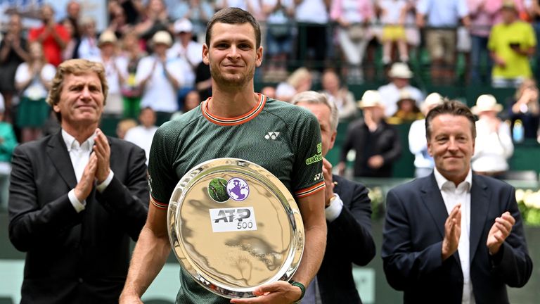 Poland's Hubert Hurkacz holds his second place trophy after he was defeated by Italy's Jannik Sinner in the men's singles final tennis match of the ATP 500 Halle Open tennis tournament in Halle, western Germany on June 23, 2024. (Photo by CARMEN JASPERSEN / AFP)