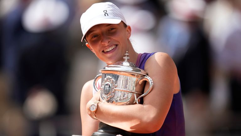 Poland's Iga Swiatek celebrates with the trophy after winning the women's final of the French Open tennis tournament against Italy's Jasmine Paolini at the Roland Garros stadium in Paris, France, Saturday, June 8, 2024. (AP Photo/Christophe Ena)