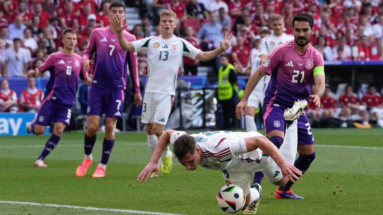 Hungary's Willi Orban falls on the ball while defending near the goal during a Group A match between Germany and Hungary at the Euro 2024 soccer tournament in Stuttgart, Germany, Wednesday, June 19, 2024. (AP Photo/Darko Vojinovic)