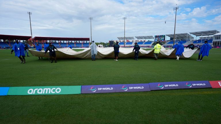 Groundsmen pull the covers off the field before an ICC Men's T20 World Cup cricket match between the United States and Ireland at the Central Broward Regional Park Stadium in Lauderhill, Fla., Friday, June 14, 2024. (AP Photo/Lynne Sladky)