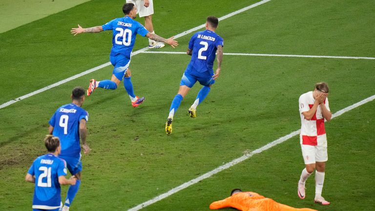 Italy's Mattia Dzacagni, top left, celebrates after scoring his team's first goal during the Group B match between Croatia and Italy at the Euro 2024 soccer tournament in Leipzig, Germany, Monday, June 24, 2024. (AP Photo/Sergei Grits )
